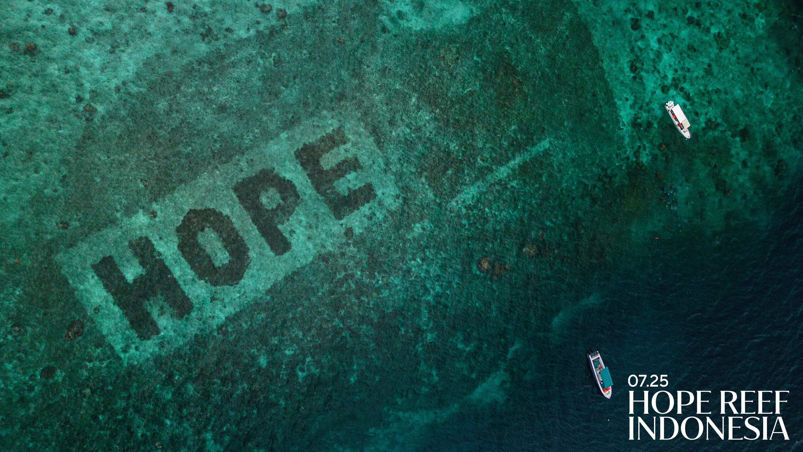 Aerial reef with coral spelling 'HOPE'; text reads '07.25 HOPE REEF INDONESIA' with boats nearby.